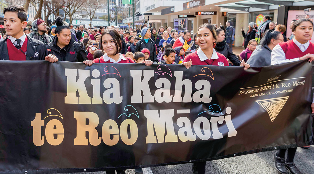 Image of students marching to celebrate a language