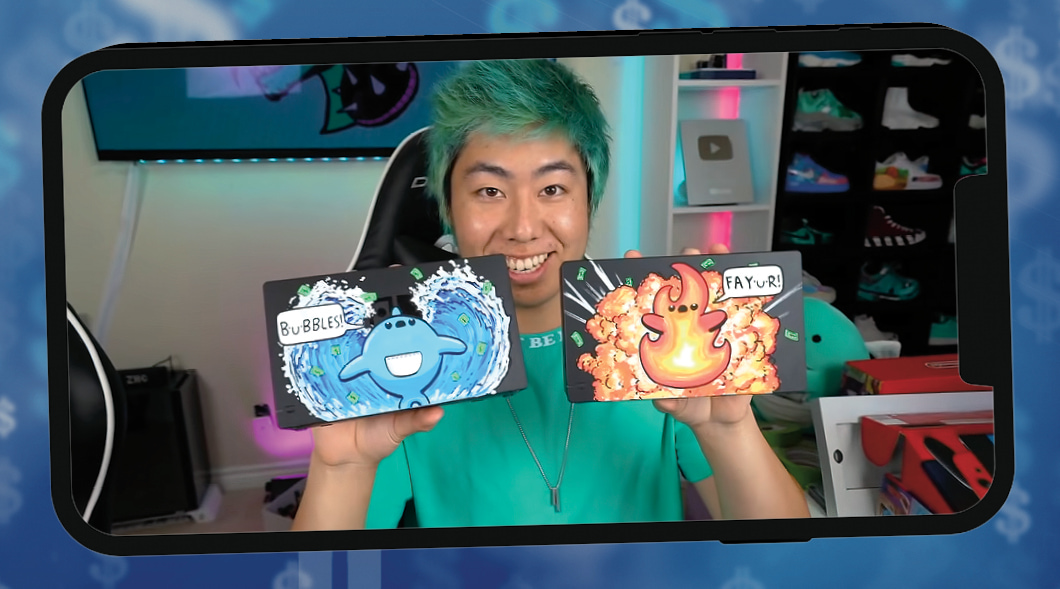 Youtuber holding up a card with a water character and another card with a fire character