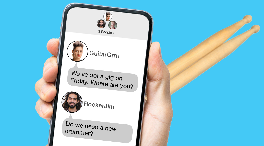 Hand holding a cellphone and drumsticks
