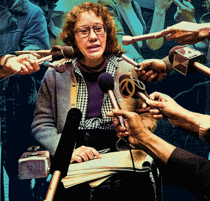 Photo of a person being interviewed by many microphones