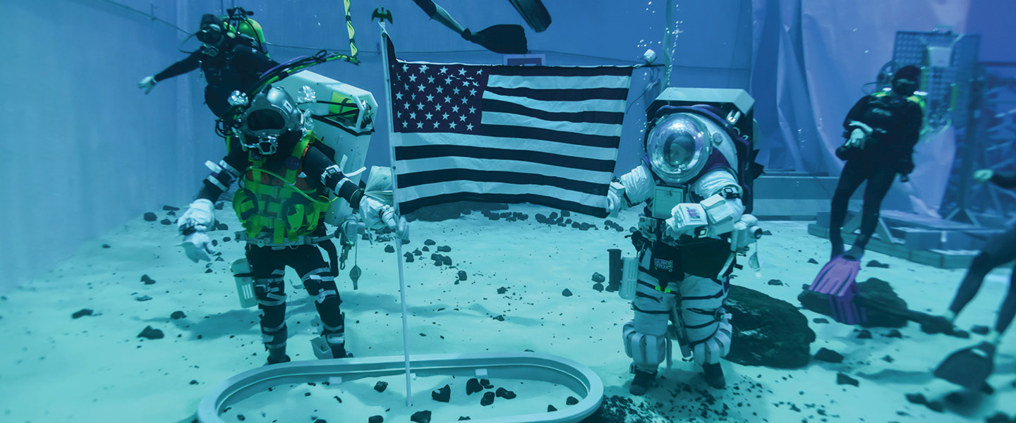 Photo of an astronaut and scuba divers underwater