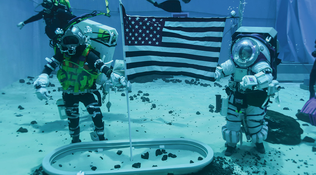 Photo of an astronaut and scuba divers underwater