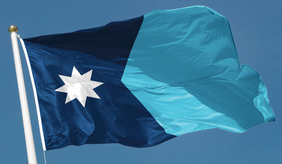Photo of a two-toned blue flag with white star