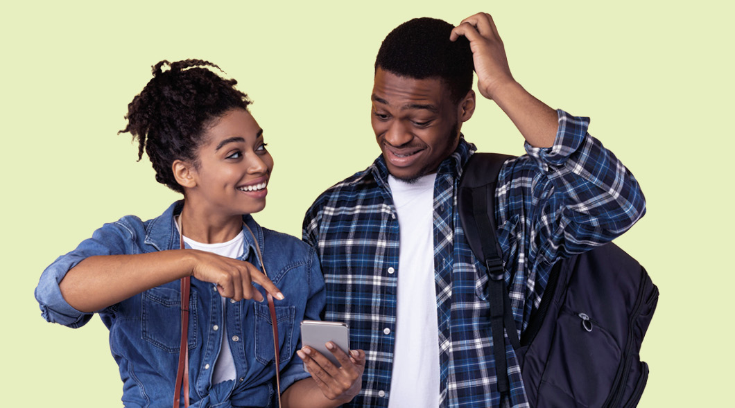 Image of a person showing another person something on their phone & them looking uncomfortable
